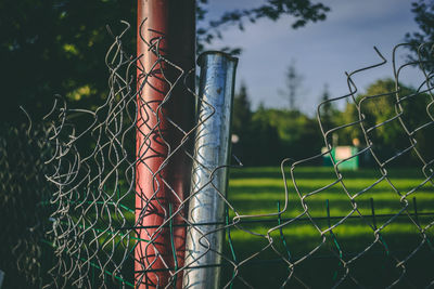 Close-up of barbed wire fence on field