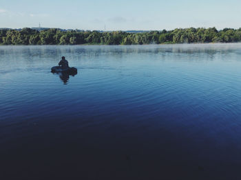 Man canoeing on lake