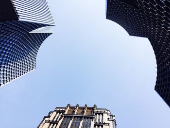 Low angle view of buildings against blue sky