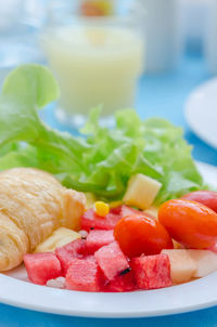 Close-up of chopped fruits in plate on table