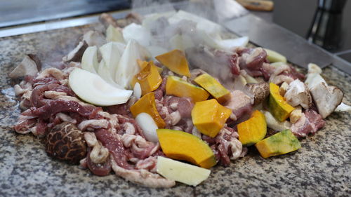 Duck, pumpkin and mushrooms grilled on a stone plate. korean cuisine.