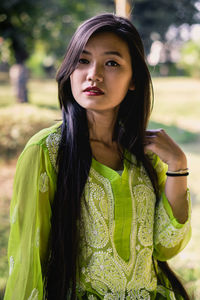 Portrait of beautiful young woman standing outdoors