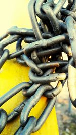 Close-up of chain tied up of metal fence