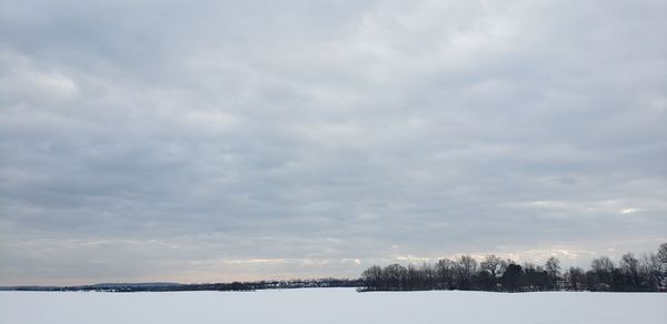 Scenic view of lake against sky during winter