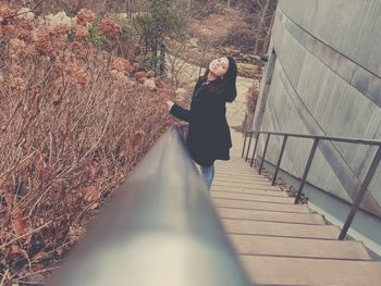 Woman standing on railing