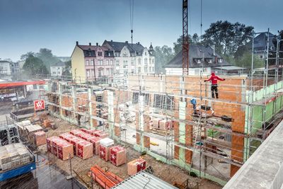 Construction site against sky in city
