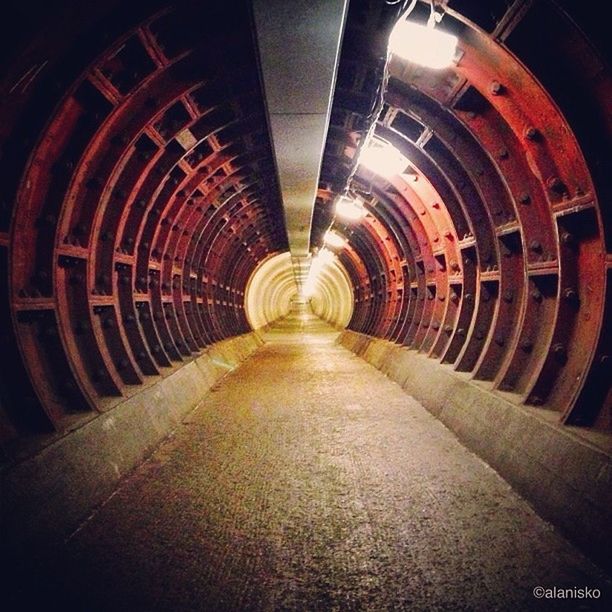 the way forward, diminishing perspective, vanishing point, tunnel, indoors, transportation, illuminated, architecture, built structure, arch, railroad track, empty, long, no people, narrow, lighting equipment, rail transportation, absence, night, wall - building feature