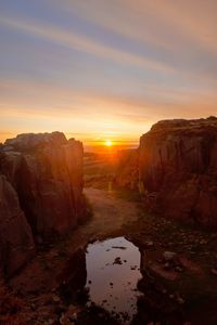 Scenic view of rock formation against sky during sunset