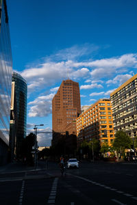 City street and buildings against sky