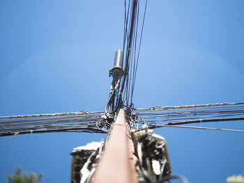 Low angle view of sailboat against clear blue sky