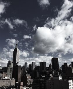 Cityscape against cloudy sky