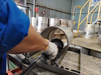 Midsection of man working at workshop