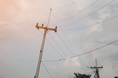 Low angle view of electricity pylon against sky