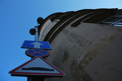 Low angle view of road sign against clear sky