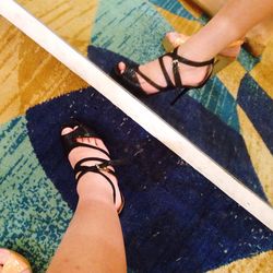 Low section of woman standing on tiled floor
