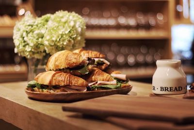 Sandwiches served on table by flower pot