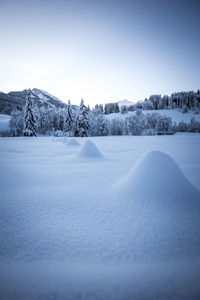 Scenic view of snow covered landscape against sky