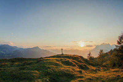 Scenic view of cross on a  hill in the mountains against clear sky