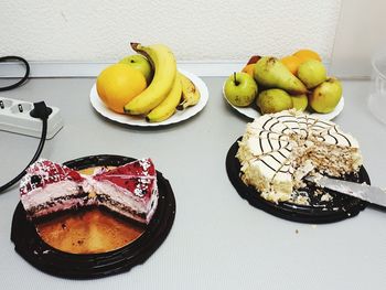 High angle view of cakes with fruits on table