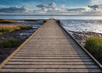 Pier over sea against sky