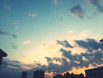 Low angle view of silhouette city against sky