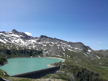 Scenic view of snowcapped mountains against clear blue sky