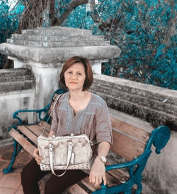 Portrait of smiling young woman sitting on seat