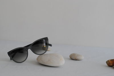 Close-up of sunglasses on table against white background