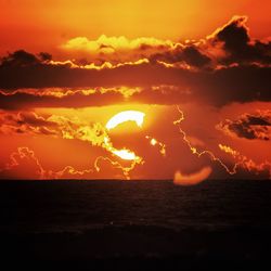 Scenic view of sea against romantic sky at sunset