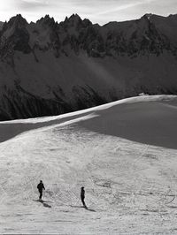 High angle view of people skiing on snowcapped mountain