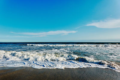 Scenic view of sea against blue sky