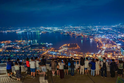 High angle view of illuminated cityscape against sky at night