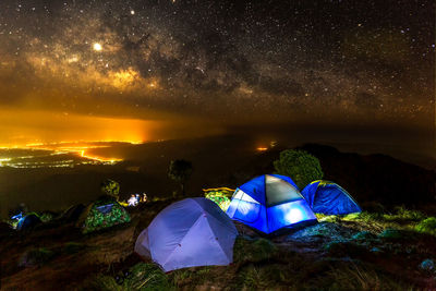 Scenic view of tent on field against sky at night