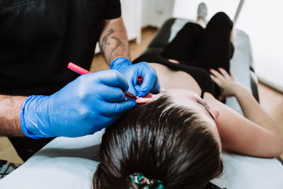 Midsection of couple holding hands