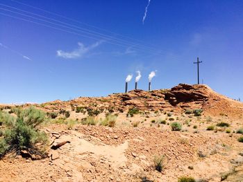 Low angle view of mountain against blue sky