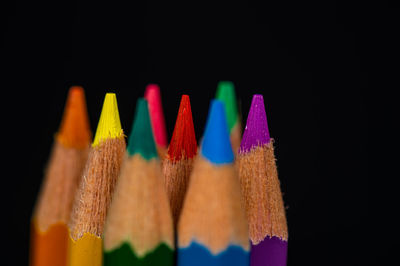 Close-up of multi colored pencils against black background