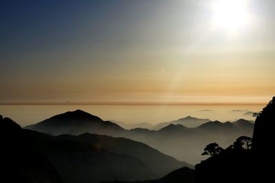 Scenic view of silhouette mountains against sky during sunset