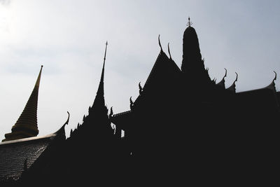 Low angle view of silhouette temple against sky