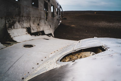 Close-up of abandoned car on land