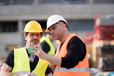 Workers using phone at construction site