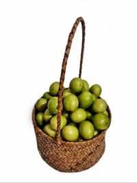Close-up of fruits in basket on white background