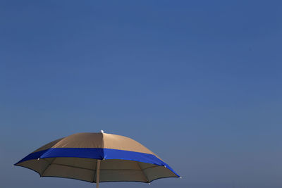 Umbrella against clear blue sky