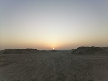 Scenic view of desert against sky during sunset