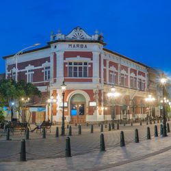 Illuminated building against blue sky