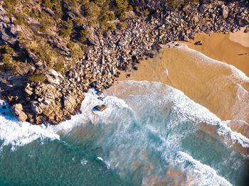 High angle view of rocks on sea shore