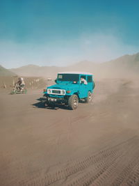 View of car on desert land