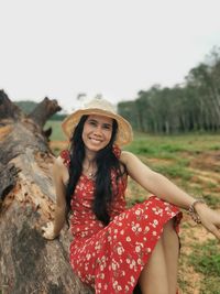 Young woman wearing hat standing on rock