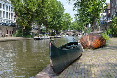 Boats moored on canal in city