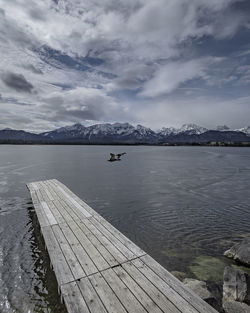 Pier over lake against sky