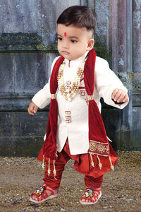 Boy wearing traditional clothes at home